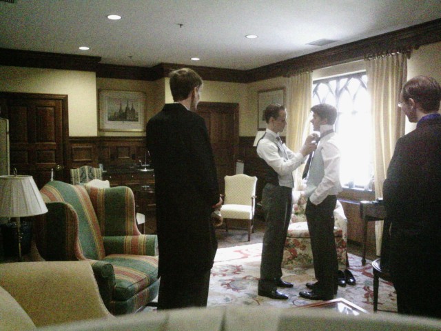 Getting ready for the wedding, helping my best man with his tie.