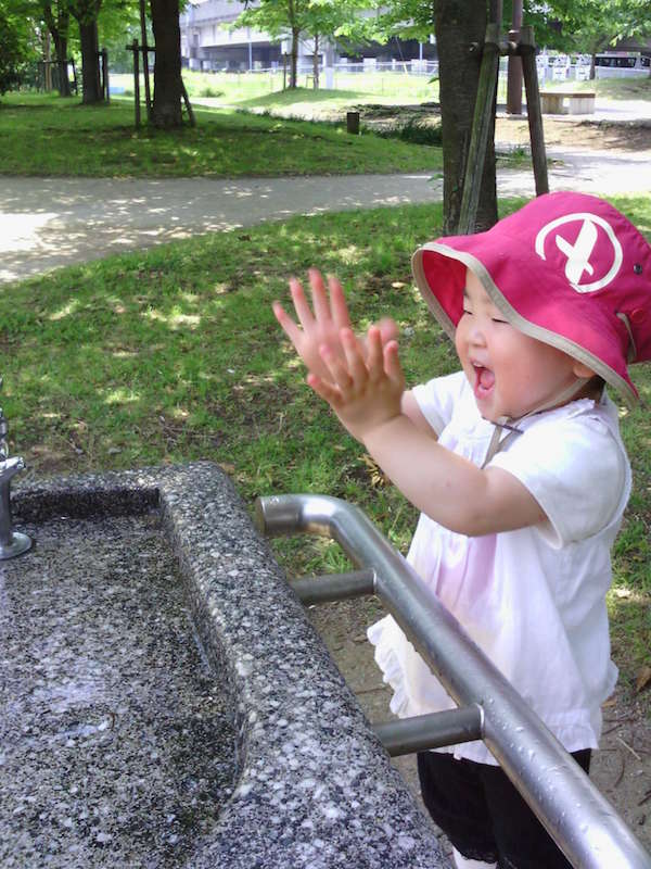 Baby playing in fountain